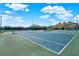 Well-maintained tennis courts with clubhouse in background at 17112 Downs Dr, Odessa, FL 33556