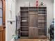 Well-organized laundry room with custom shelving, washer, dryer, and door to the outside at 1920 E Idlewild Ave, Tampa, FL 33610