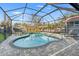 Backyard oasis featuring a screened-in pool and deck, perfect for outdoor entertaining and leisure at 1920 E Idlewild Ave, Tampa, FL 33610