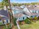 Aerial view of a well-maintained single-Gathering home with lush landscaping and solar panels at 20033 Heritage Point Dr, Tampa, FL 33647
