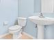 Cozy half bathroom featuring a modern sink and toilet for added convenience at 20033 Heritage Point Dr, Tampa, FL 33647