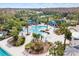 View of community pool with lounge chairs, palm trees, and sunshades at 20033 Heritage Point Dr, Tampa, FL 33647