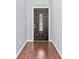 Elegant foyer with rich hardwood flooring, a stylish front door, and neutral wall paint at 20033 Heritage Point Dr, Tampa, FL 33647