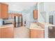 Spacious kitchen featuring stainless steel appliances, wooden cabinets, and a bar, perfect for entertaining at 20033 Heritage Point Dr, Tampa, FL 33647