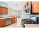 Modern kitchen featuring stainless steel appliances, wooden cabinets, and a tiled floor layout at 20033 Heritage Point Dr, Tampa, FL 33647
