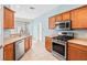 Fully equipped kitchen featuring stainless steel appliances and wooden cabinets for ample storage at 20033 Heritage Point Dr, Tampa, FL 33647