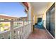 Balcony overlooking the beautiful courtyard with red tile floors, a vintage seat, and white rails at 210 22Nd Ne Ave # 14, St Petersburg, FL 33704