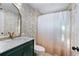 Updated bathroom with a marble vanity, modern gold fixtures, and a shower with a decorative curtain at 210 22Nd Ne Ave # 14, St Petersburg, FL 33704