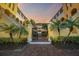 Grand entrance featuring lush landscaping, a secure gate, and charming architecture in this inviting community at 210 22Nd Ne Ave # 14, St Petersburg, FL 33704