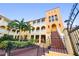 Mediterranean-style apartment building with red-tiled stairs, lush landscaping, and inviting walkways at 210 22Nd Ne Ave # 14, St Petersburg, FL 33704