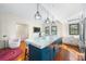 Kitchen island with marble countertop, blue cabinets, hardwood floors and pendant lighting at 210 22Nd Ne Ave # 14, St Petersburg, FL 33704