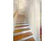 Hardwood staircase with white risers and wood handrail at 210 22Nd Ne Ave # 14, St Petersburg, FL 33704