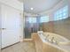 Bathroom with soaking tub, shower, and tiled floors at 26848 Shoregrass Dr, Wesley Chapel, FL 33544