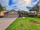 Two-story house with a two-car garage and nicely landscaped lawn at 26848 Shoregrass Dr, Wesley Chapel, FL 33544