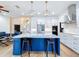 Modern kitchen with white cabinets, blue island, and quartz countertops at 26848 Shoregrass Dr, Wesley Chapel, FL 33544