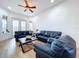 Spacious living room featuring comfortable blue leather sofas at 26848 Shoregrass Dr, Wesley Chapel, FL 33544