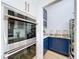 Well-organized pantry with ample shelving and blue cabinetry at 26848 Shoregrass Dr, Wesley Chapel, FL 33544