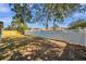 Large backyard with white vinyl fence and grassy area at 2904 Matchlock Dr, Holiday, FL 34690