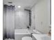 Updated bathroom with a tub shower combo and white vanity at 2904 Matchlock Dr, Holiday, FL 34690