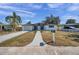 Front view of a renovated single story home with white brick exterior at 2904 Matchlock Dr, Holiday, FL 34690