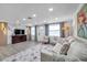 Open concept living room with a marble accent wall and large TV at 2904 Matchlock Dr, Holiday, FL 34690