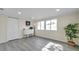 Light-filled living room with large windows and wood-look floors at 2904 Matchlock Dr, Holiday, FL 34690