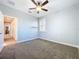 Comfortable bedroom with neutral carpet, single window, and access to other rooms at 29197 Perilli Pl, Wesley Chapel, FL 33543