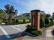 Inviting community entrance featuring brick signage and landscaping, creating a warm welcome at 29197 Perilli Pl, Wesley Chapel, FL 33543