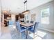 Bright dining room featuring modern lighting, gray chairs, an area rug, and natural light at 29197 Perilli Pl, Wesley Chapel, FL 33543