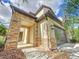 Stunning home exterior featuring stone accents, a modern garage door, and lush landscaping at 29197 Perilli Pl, Wesley Chapel, FL 33543