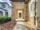 Inviting front entrance with stone accents, rain chains, and manicured landscaping at 29197 Perilli Pl, Wesley Chapel, FL 33543