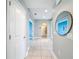 Bright hallway with tile flooring and arched doorways, offering a glimpse into the home's layout at 29197 Perilli Pl, Wesley Chapel, FL 33543