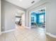 Bright hallway with tile flooring leading to a room painted blue, offering a glimpse into the home's layout at 29197 Perilli Pl, Wesley Chapel, FL 33543