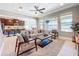 Open-concept living room showcasing stylish furniture, natural light, and seamless flow to the kitchen at 29197 Perilli Pl, Wesley Chapel, FL 33543