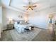 Serene main bedroom with tray ceiling, ceiling fan, and a calming, neutral color palette at 29197 Perilli Pl, Wesley Chapel, FL 33543