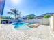 Backyard pool and spa feature a brick-paved patio and privacy fence at 29197 Perilli Pl, Wesley Chapel, FL 33543