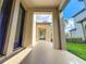 Covered front porch featuring stone accents, providing a shaded entryway to the home at 29197 Perilli Pl, Wesley Chapel, FL 33543