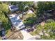 Aerial view of a beautiful home showcasing its large yard, mature trees, solar panels, and ample parking at 3087 Duane Ave, Oldsmar, FL 34677