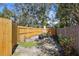 Fenced backyard featuring a fire pit, picnic table, and well-maintained lawn at 3087 Duane Ave, Oldsmar, FL 34677