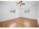 Bright bedroom with hardwood floors, two windows and a ceiling fan at 3087 Duane Ave, Oldsmar, FL 34677