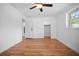 Bedroom features hardwood floors, white walls and trim, closet, and a ceiling fan at 3087 Duane Ave, Oldsmar, FL 34677