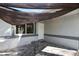 Covered front porch with decorative table on a stone tile surface for outdoor lounging at 3087 Duane Ave, Oldsmar, FL 34677