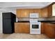 Bright kitchen features wood cabinets, granite countertops, and a white oven and microwave at 3087 Duane Ave, Oldsmar, FL 34677