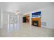 Bright living room with tiled floor, fireplace, and access to the kitchen at 3087 Duane Ave, Oldsmar, FL 34677