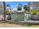 View of the backyard shed, providing ample storage space, surrounded by trees and a well-maintained lawn at 3087 Duane Ave, Oldsmar, FL 34677