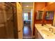 View into bedroom from bathroom with double sink vanity and tiled shower with glass doors at 3244 Mangrove Point Dr, Ruskin, FL 33570