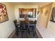 Cozy dining area next to the kitchen, featuring a dark wood table and chairs, perfect for enjoying meals with Gathering and friends at 3244 Mangrove Point Dr, Ruskin, FL 33570