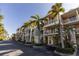 Multi-story townhomes featuring private balconies, garages, and tropical landscaping at 3244 Mangrove Point Dr, Ruskin, FL 33570