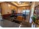 Well-lit kitchen with stainless steel appliances, light wood cabinets, and a dark countertop, offering a modern and functional space at 3244 Mangrove Point Dr, Ruskin, FL 33570