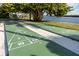 Well-maintained shuffleboard courts nestled amid lush landscaping, offering a fun and engaging outdoor activity at 3244 Mangrove Point Dr, Ruskin, FL 33570